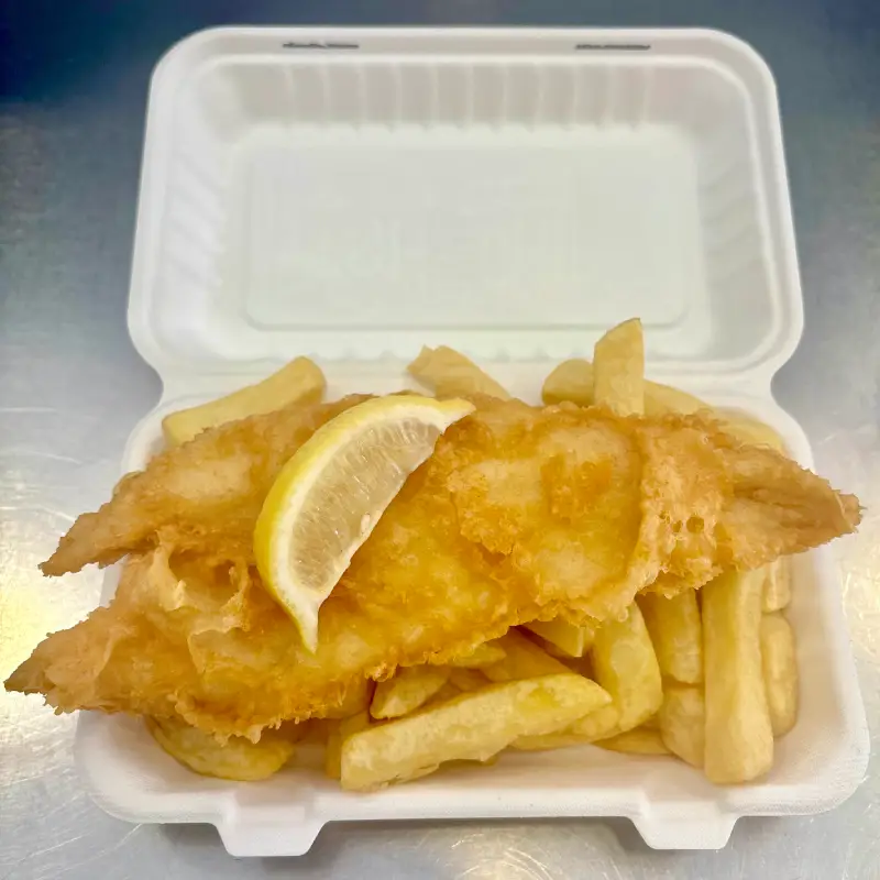 A portion of high quality Harbour Lights Falmouth fish and chips in a bio-degradable takeaway box